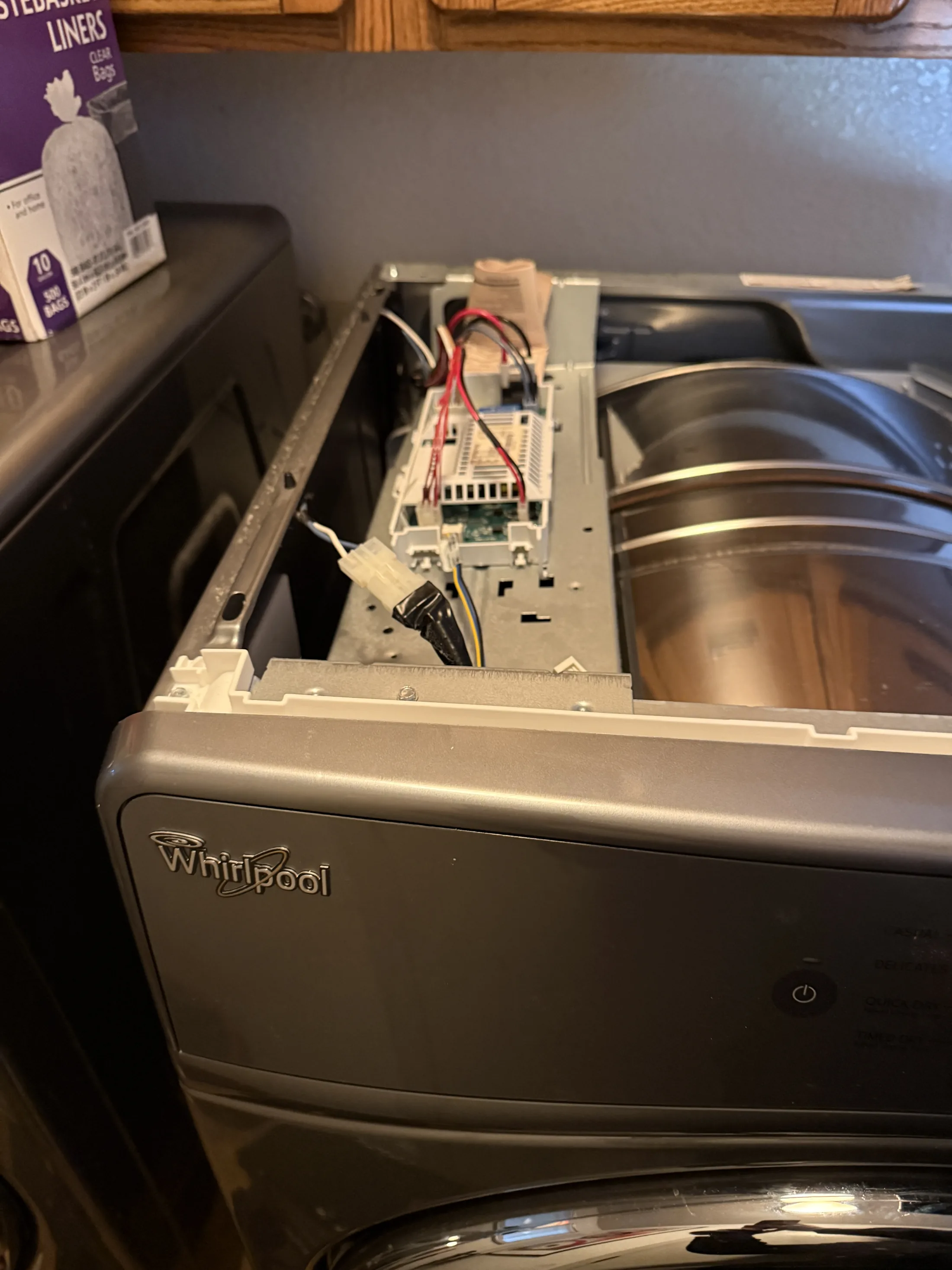 Laundry appliance opened for a control board and wiring inspection